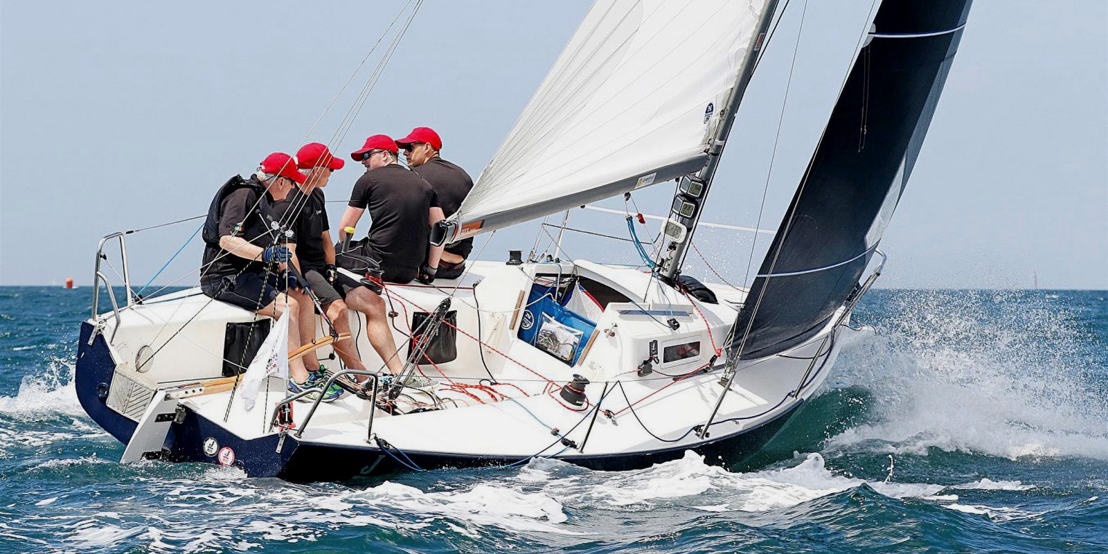 J/80 sportboat sailing in strong conditions